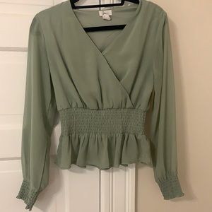 Green long-sleeved top with cinched waist